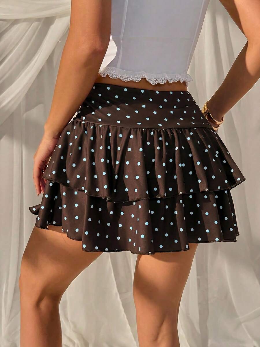 Black low waist knit mini skirt featuring a tiered ruffle hem and skinny high stretch fit.