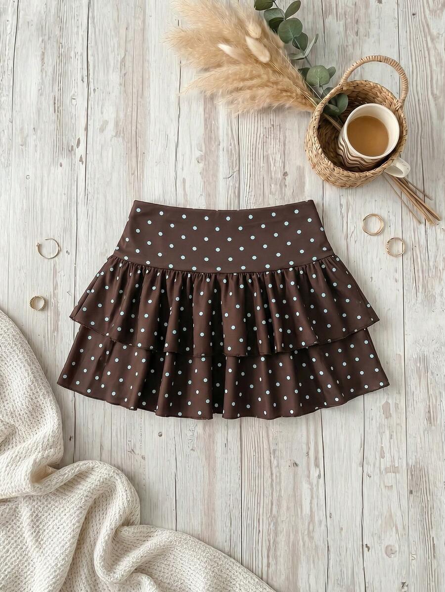 Black low waist knit mini skirt featuring a tiered ruffle hem and skinny high stretch fit.