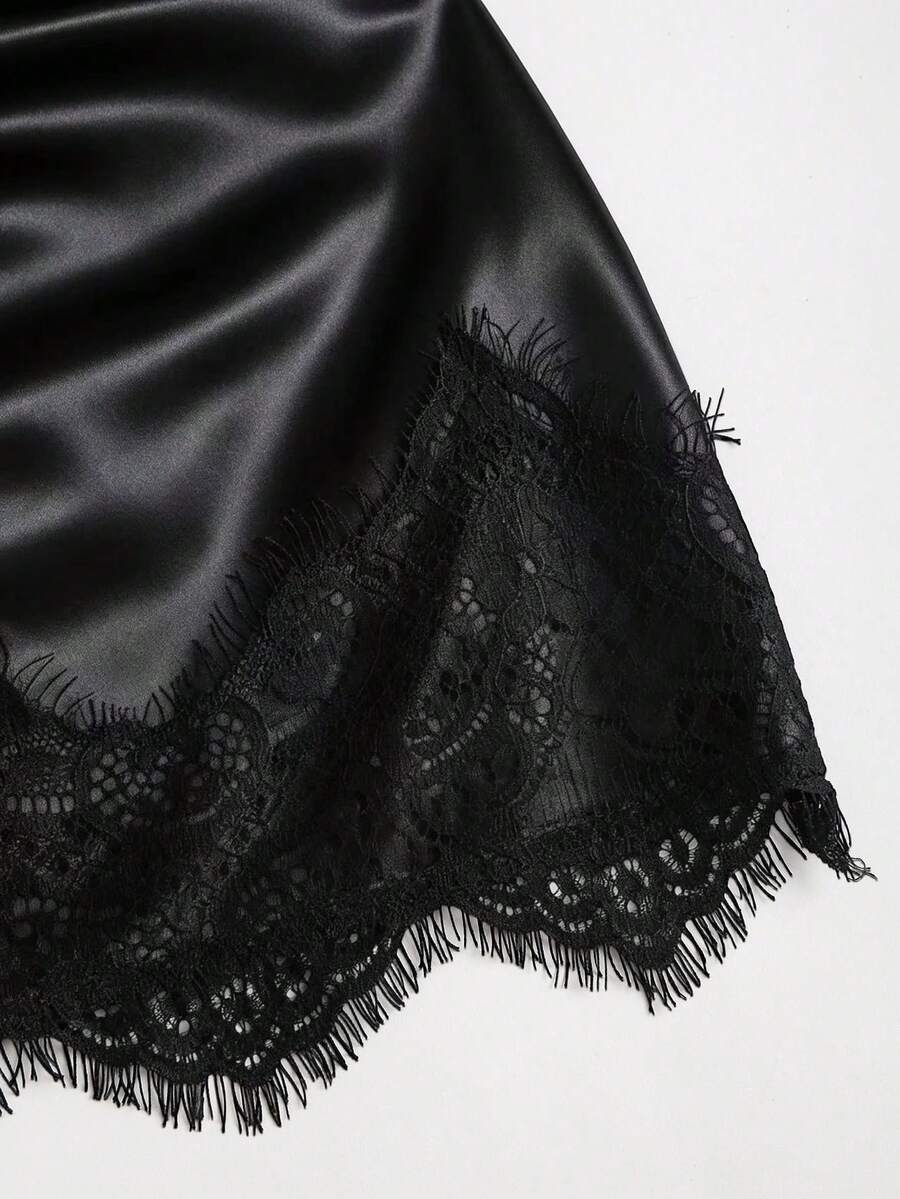 Black satin bodycon short skirt featuring contrast lace trim and mid-waist fit for women