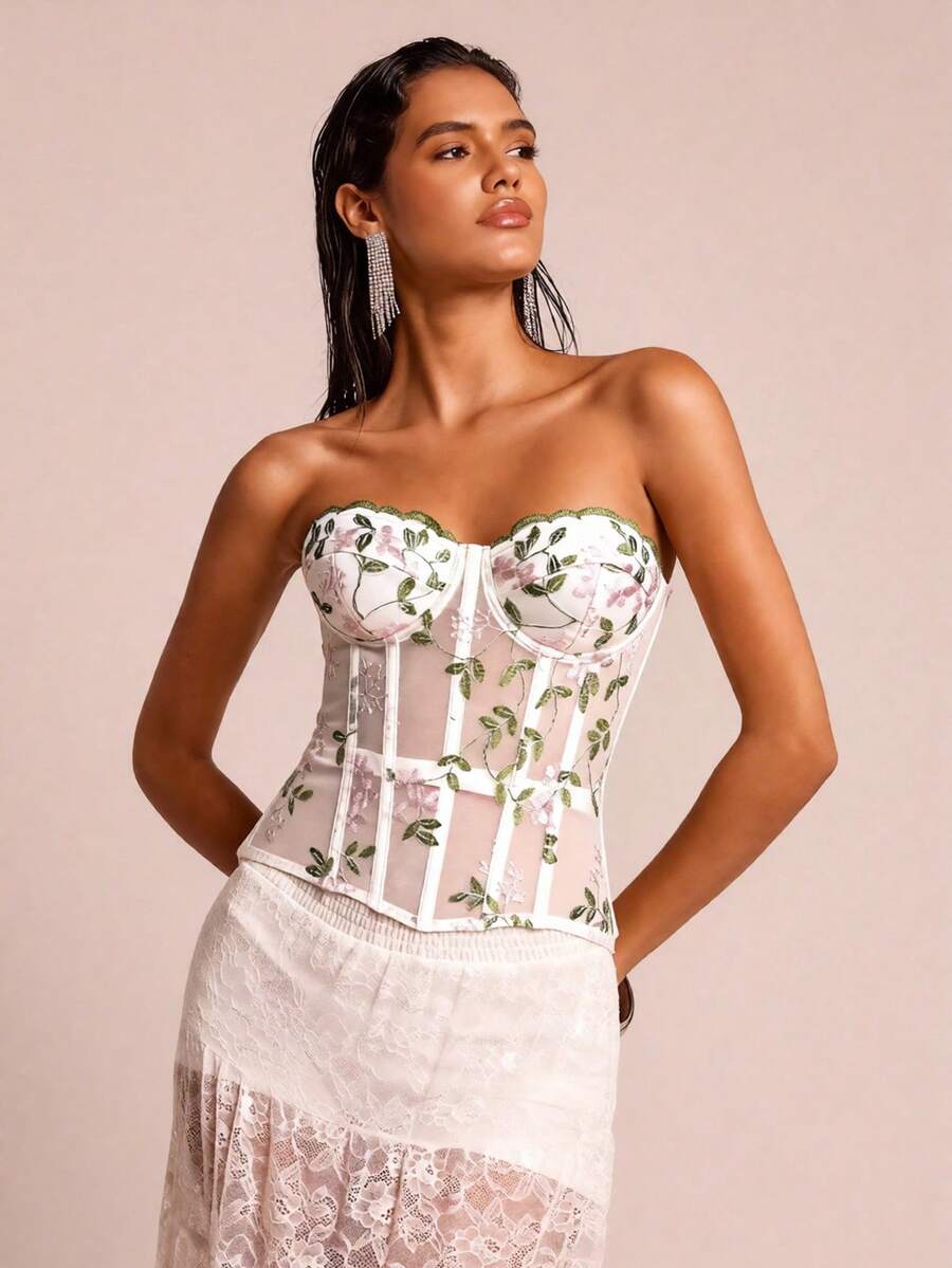 White botanical embroidered mesh bustier crop top for women featuring a strapless boned silhouette and slim crop fit.