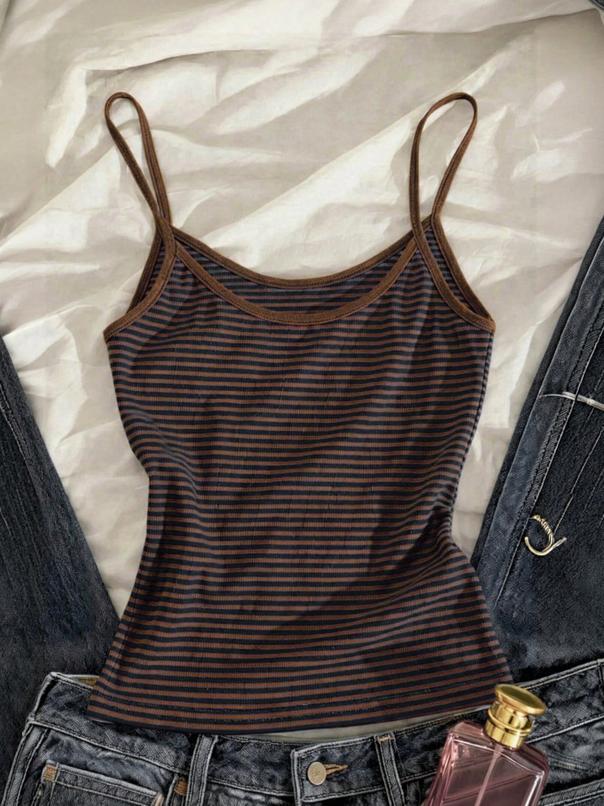 Women's pink striped crop camisole featuring criss cross spaghetti straps and slim fit design.