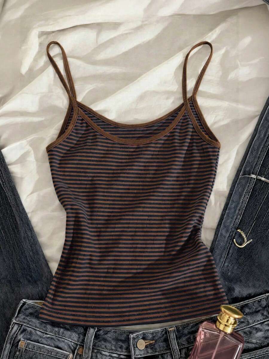 Women's pink striped crop camisole featuring criss cross spaghetti straps and slim fit design.