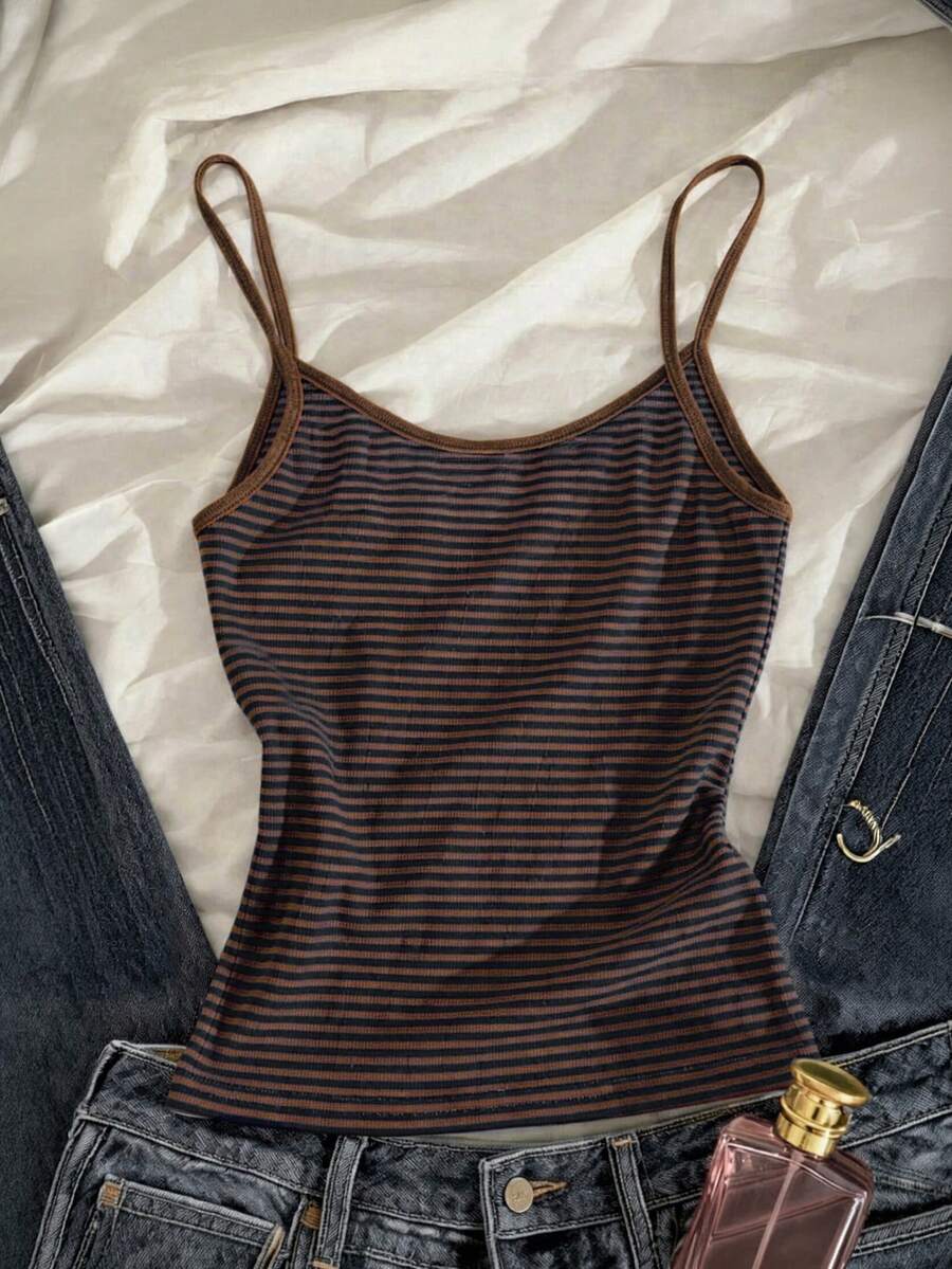 Women's pink striped crop camisole featuring criss cross spaghetti straps and slim fit design.