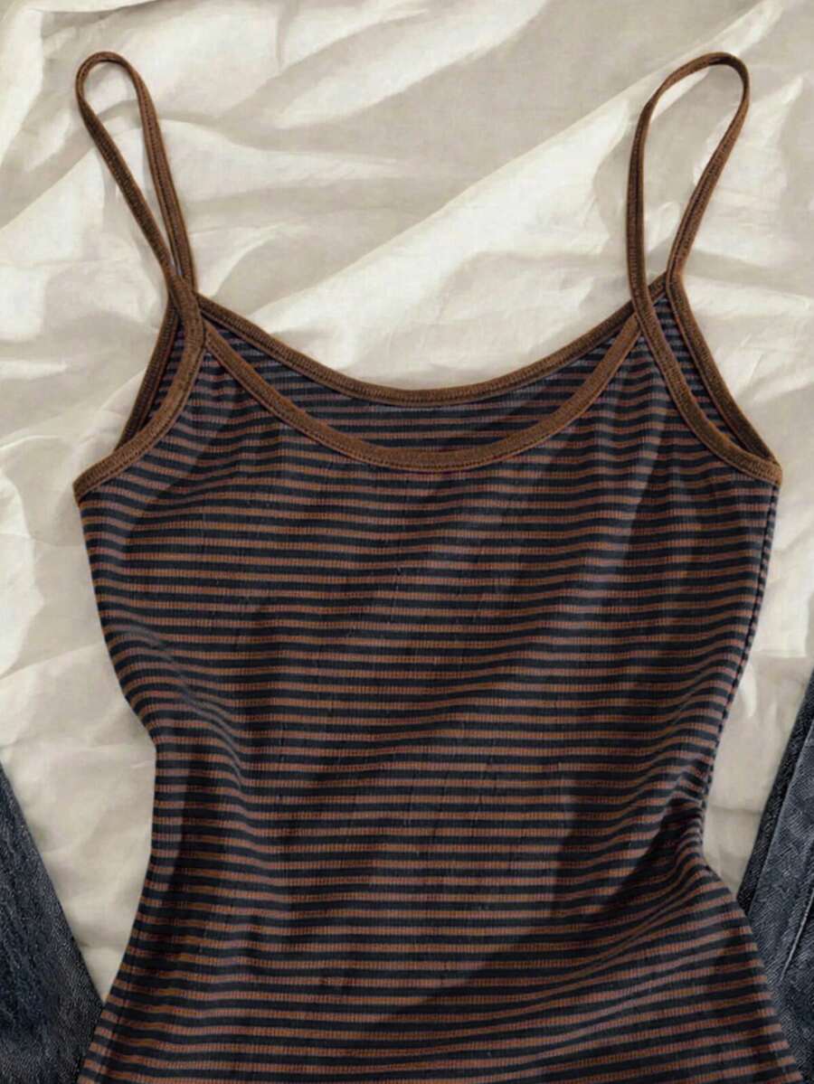 Women's pink striped crop camisole featuring criss cross spaghetti straps and slim fit design.