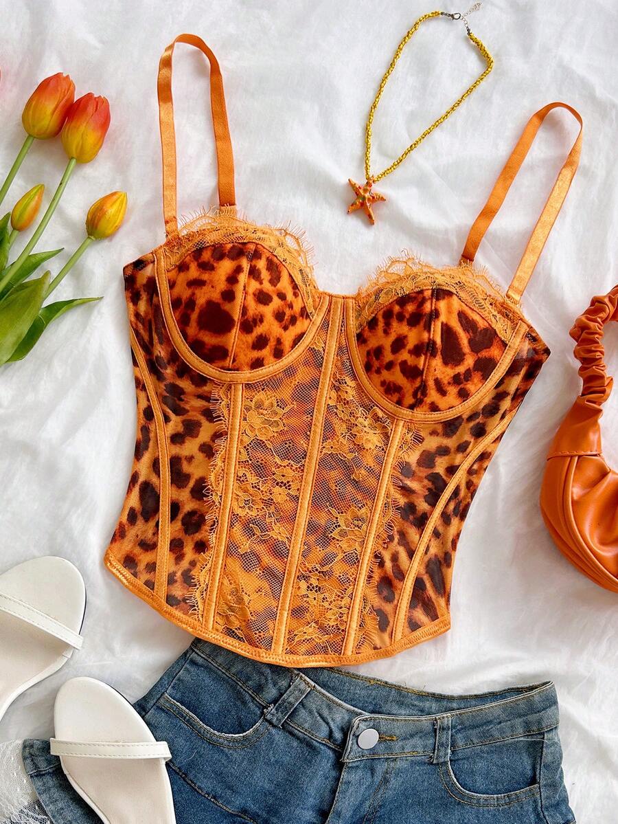 Women's lace bustier camisole top with spaghetti straps, contrast lace, lace-up detail, and an asymmetrical hem in a slim fit design.