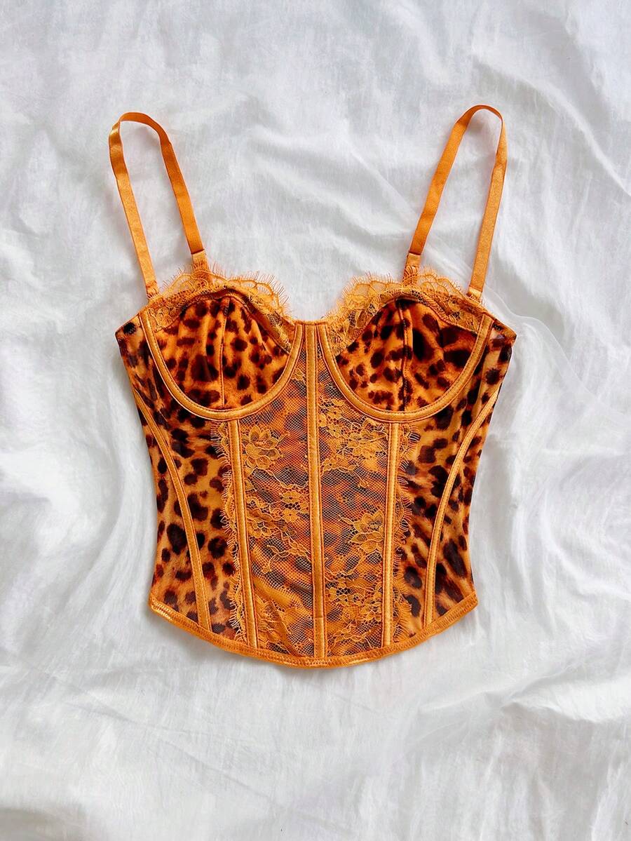 Women's lace bustier camisole top with spaghetti straps, contrast lace, lace-up detail, and an asymmetrical hem in a slim fit design.