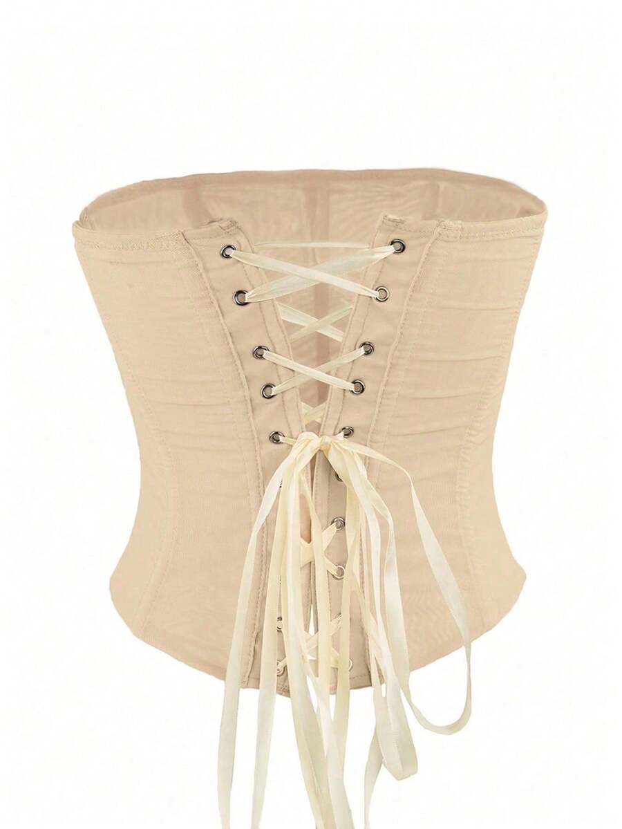 Black strapless mesh bustier top with a backless, semi-sheer design, slim fit, and crop length for women.