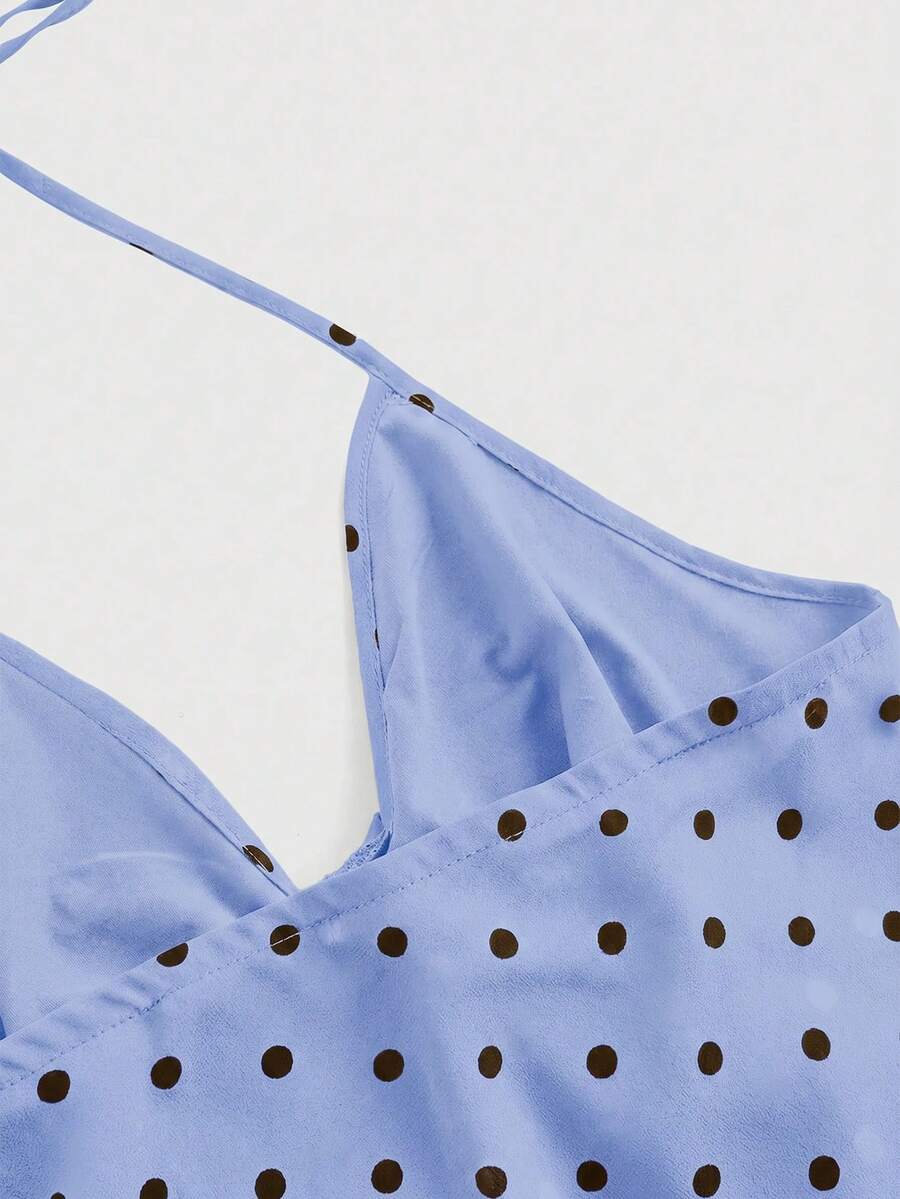 Black halter crop top featuring an asymmetrical ruffle hem and backless design for women.