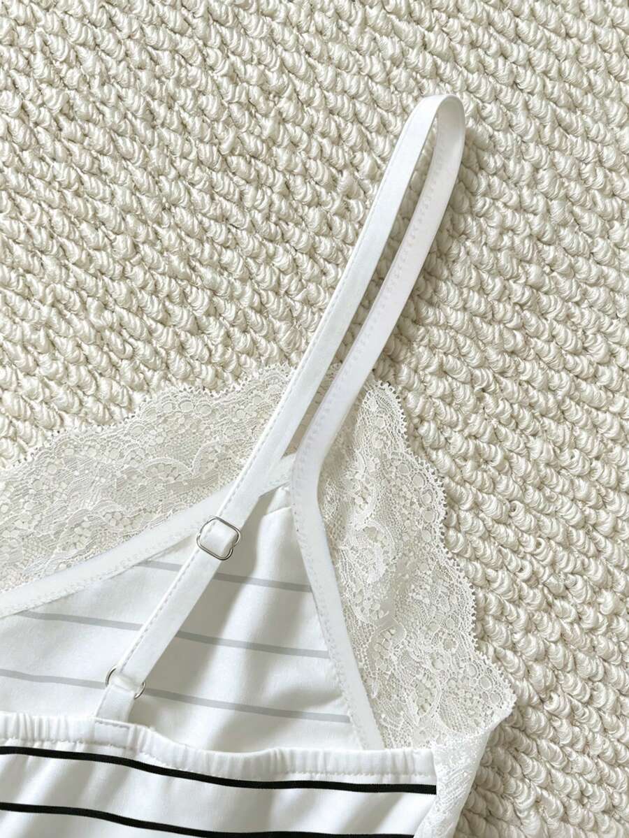 Women's solid color slim fit camisole top featuring delicate lace patchwork embroidery and tank straps.