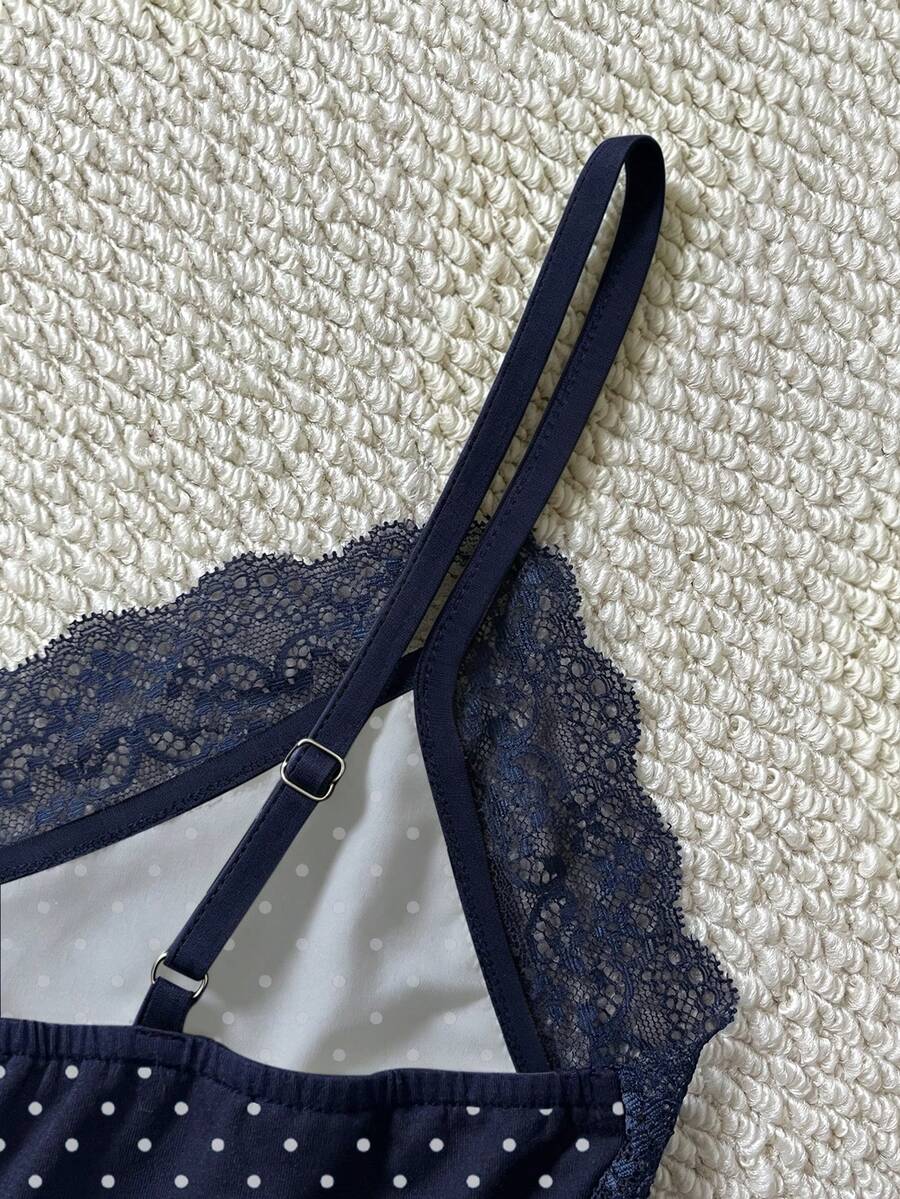 Women's solid color slim fit camisole top featuring delicate lace patchwork embroidery and tank straps.
