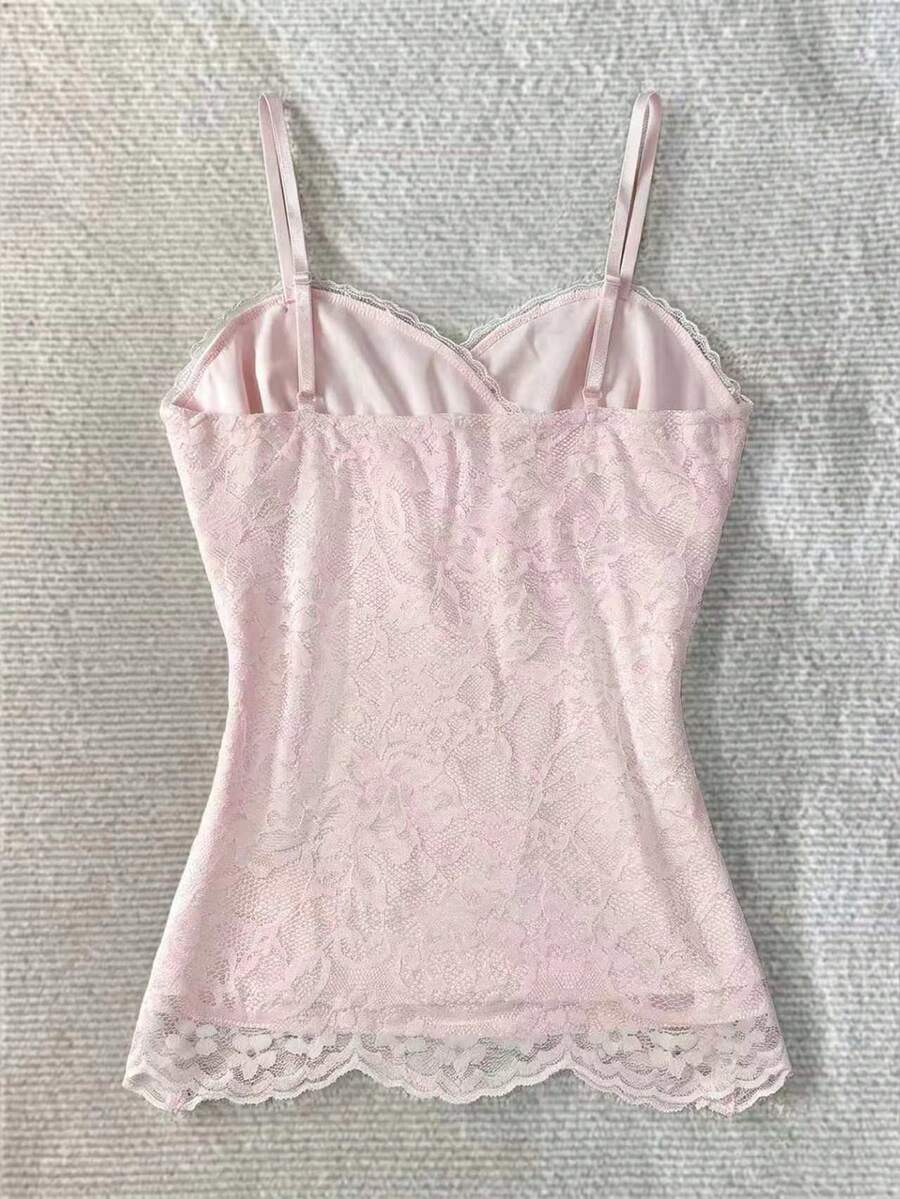 Women's solid color elegant lace cami top featuring contrast lace trim, cinched waist, spaghetti straps, and backless ring detail.