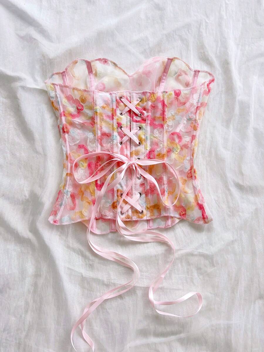 Strapless floral corset top with lace-up detail, asymmetrical hem, and slim fit for women in a boho vacation style.