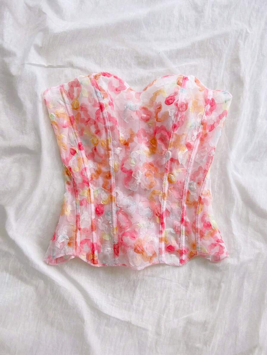 Strapless floral corset top with lace-up detail, asymmetrical hem, and slim fit for women in a boho vacation style.