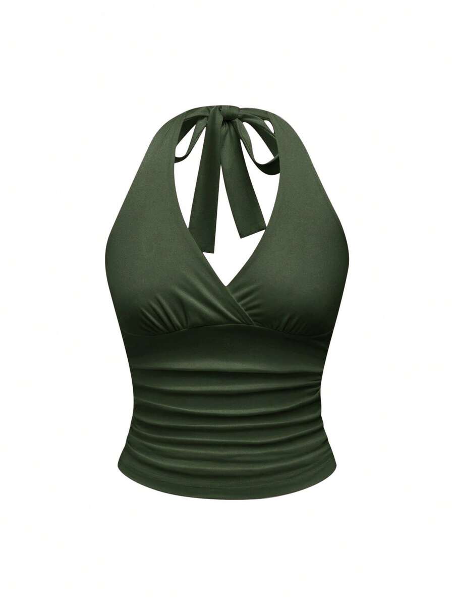 Women's halter crop tank top featuring a backless silhouette and ruched detailing in a slim fit design.