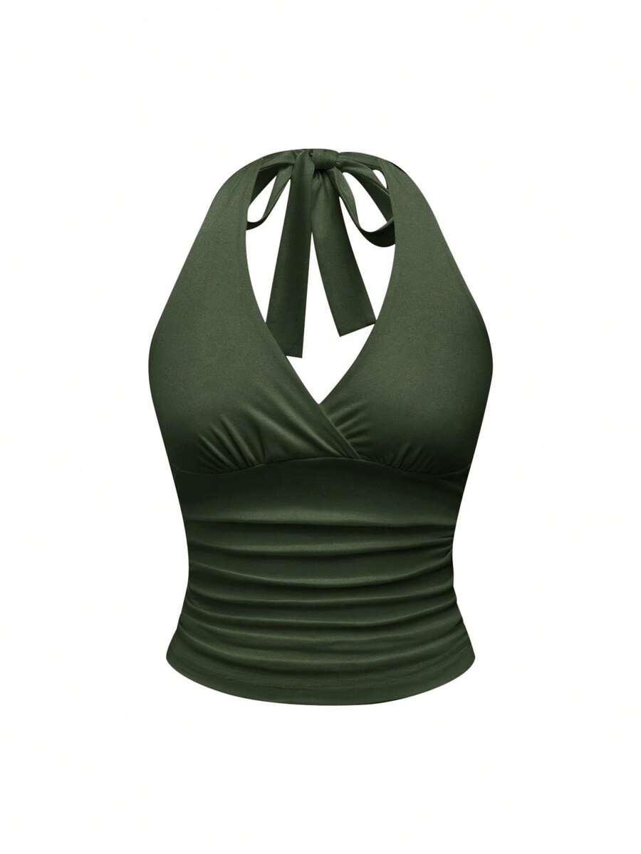 Women's halter crop tank top featuring a backless silhouette and ruched detailing in a slim fit design.