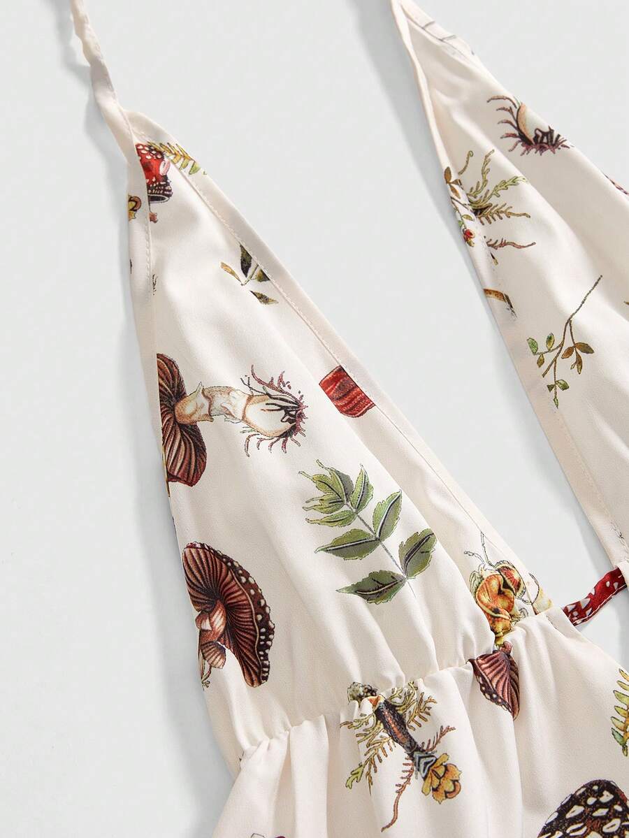 Black fairycore halter backless mini dress with mushroom, moth, and plant print featuring a high waist and flared hem.