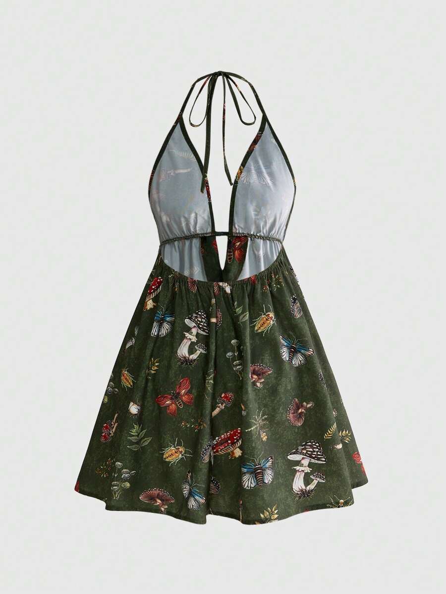 Black fairycore halter backless mini dress with mushroom, moth, and plant print featuring a high waist and flared hem.