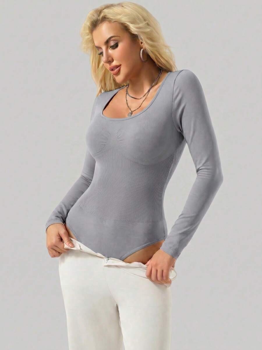 Black seamless long sleeve crew neck shapewear bodysuit for women featuring full coverage tummy control.