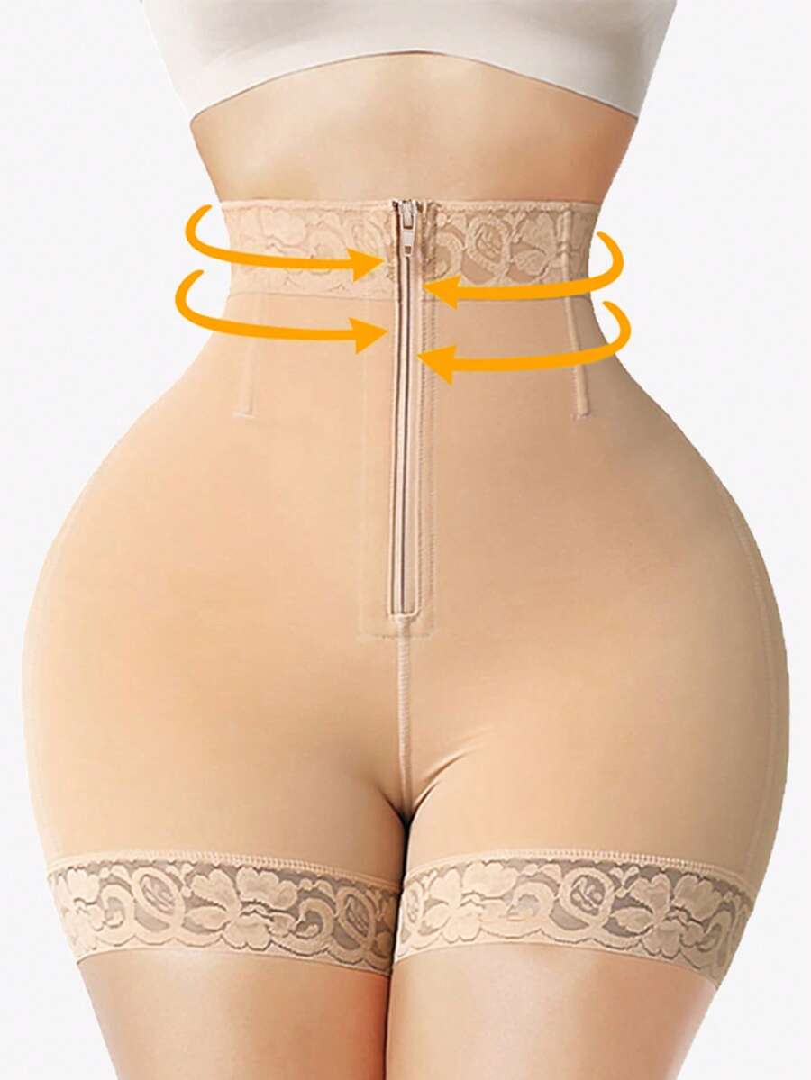 Black high waist butt lifting shapewear shorts made from mesh fabric with contrast lace trim and a front zipper for tummy and thigh shaping.
