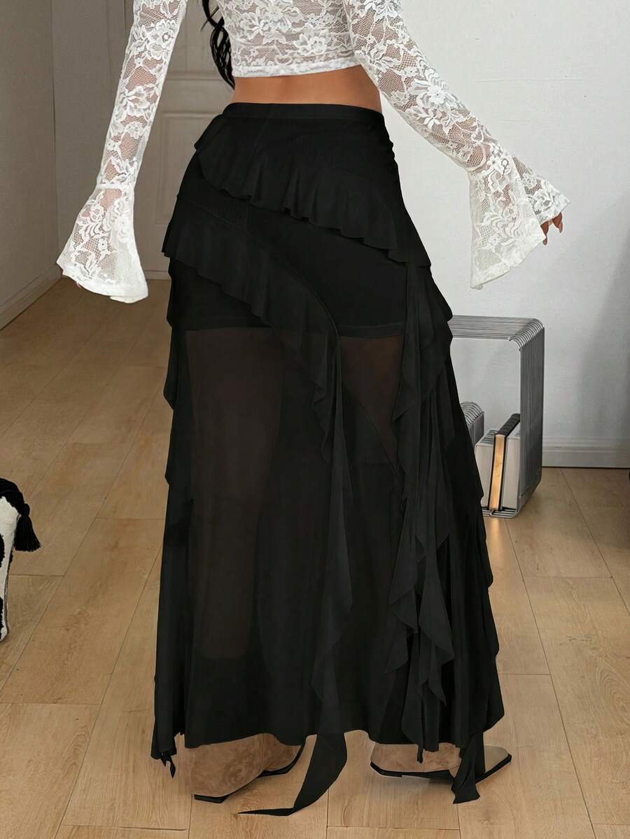 Women's low rise asymmetrical long skirt with tiered ruffle details in stretch knitted fabric.