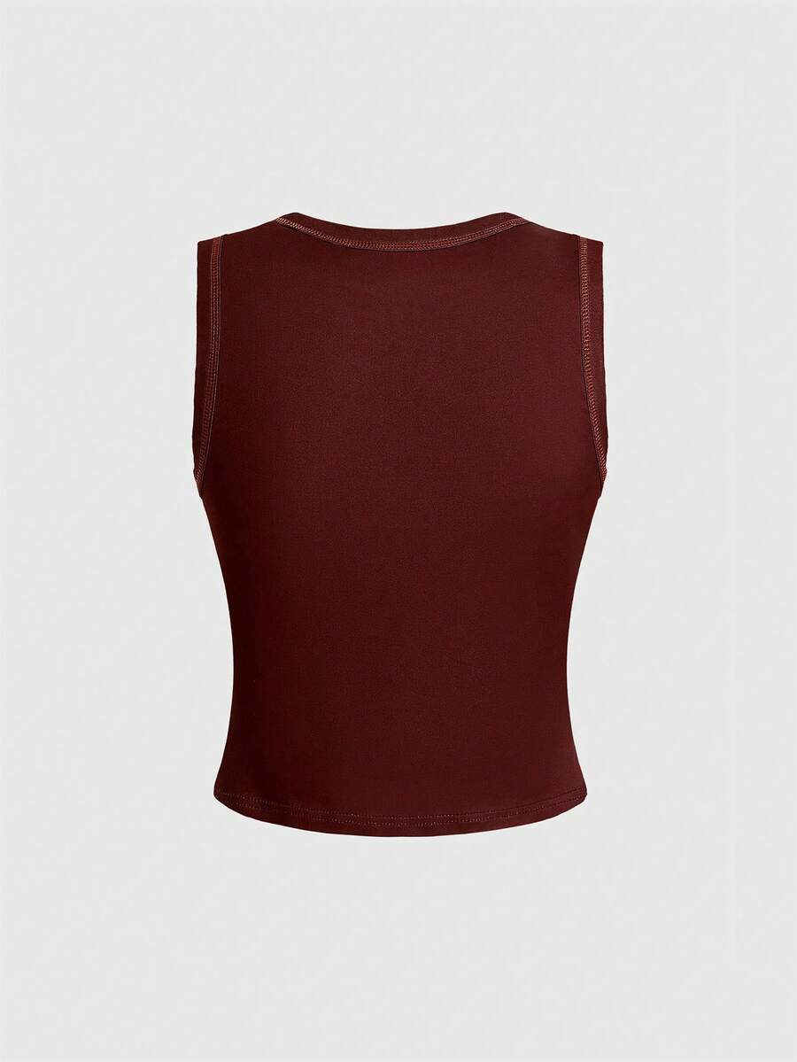 Burgundy women's crop tank top featuring contrast binding trim, graphic letter print, and a slim fit round neck silhouette.