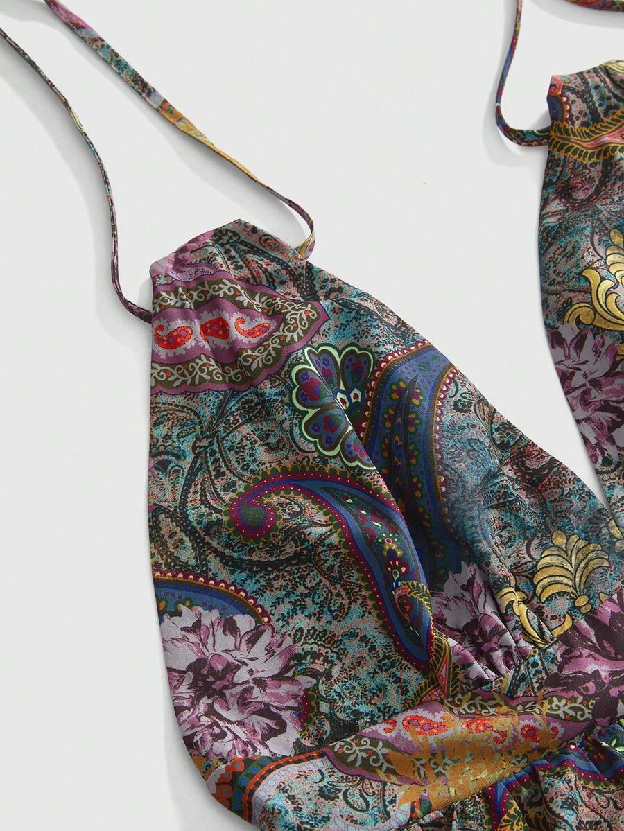 Women's multicolor paisley print halter loose mini dress featuring a backless knot detail and ruffle flounce hem