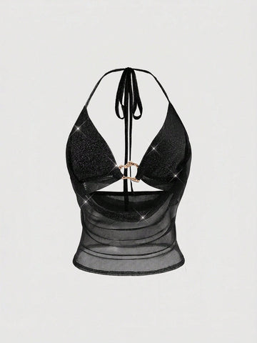 Women's glitter backless halter crop top with a draped neck and tie-up straps in metallic black knit fabric.
