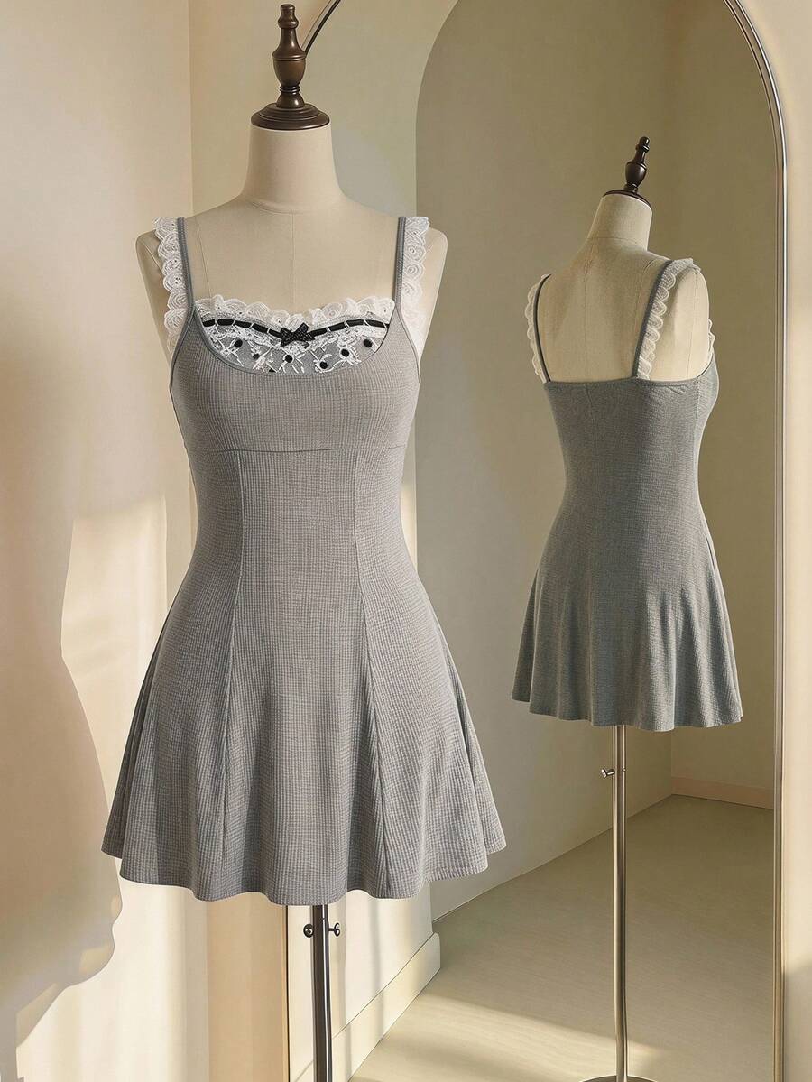 Women's sleeveless black colorblock cami mini dress with shoulder straps, frill detailing, slim fit waist, and flared hem.