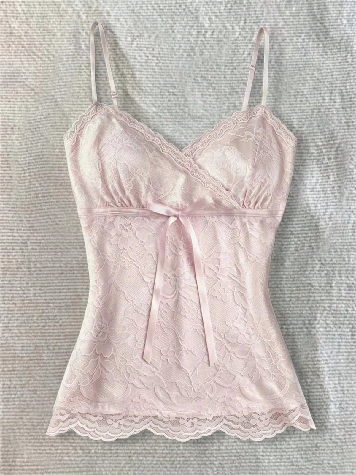 Women's solid color elegant lace cami top featuring contrast lace trim, cinched waist, spaghetti straps, and backless ring detail.