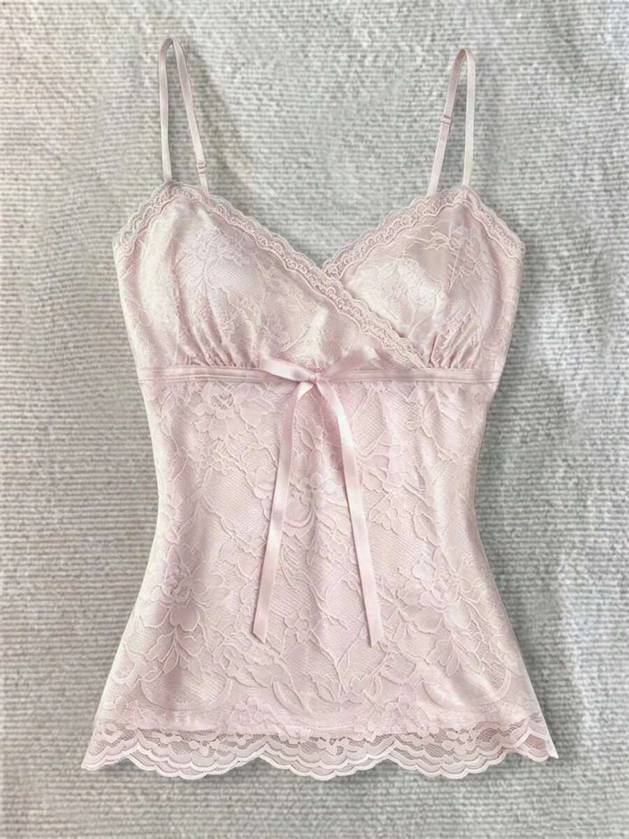 Women's solid color elegant lace cami top featuring contrast lace trim, cinched waist, spaghetti straps, and backless ring detail.