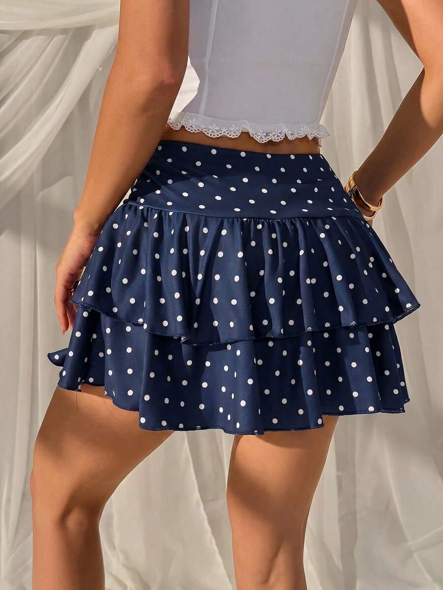 Black low waist knit mini skirt featuring a tiered ruffle hem and skinny high stretch fit.