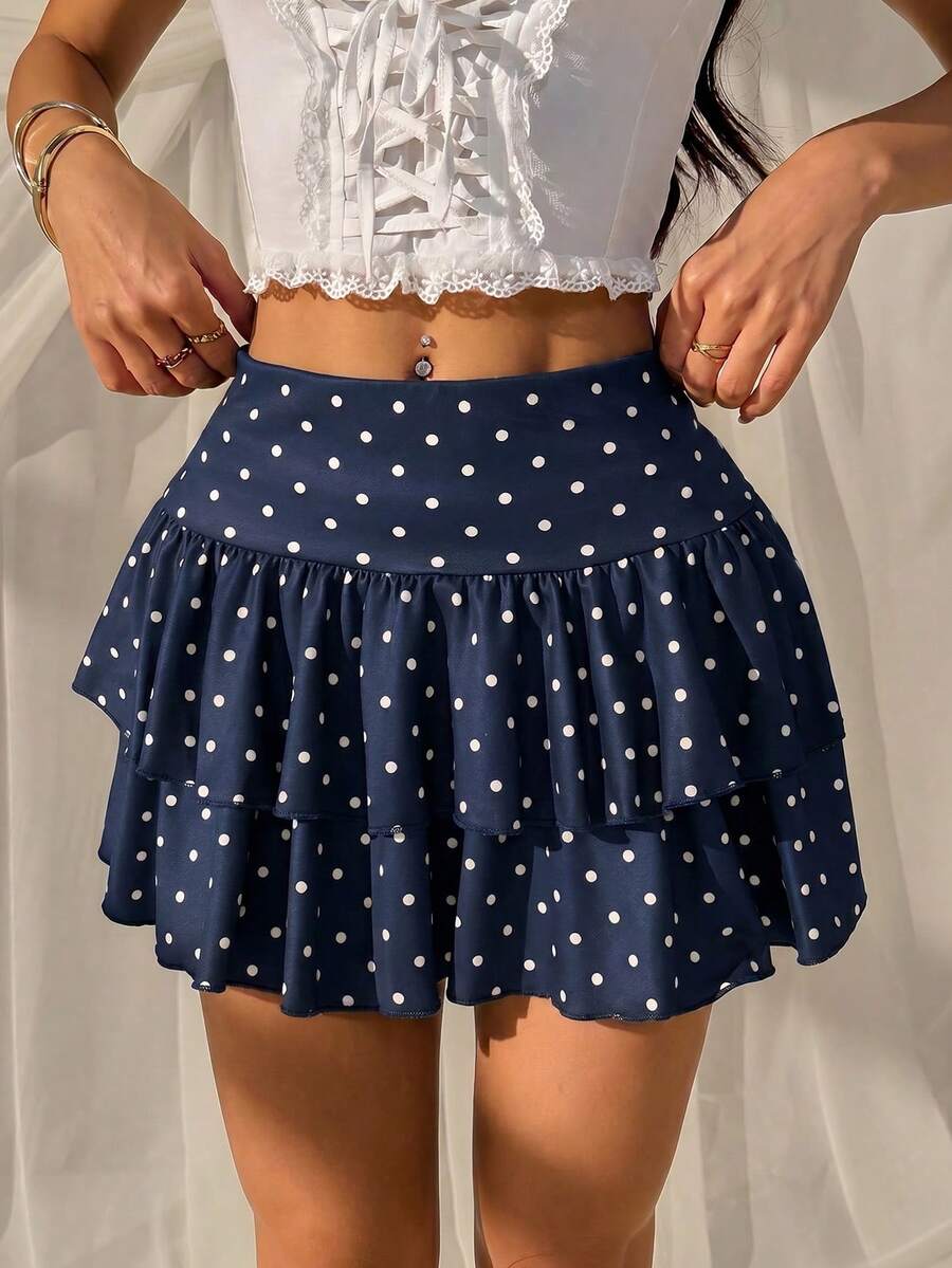 Black low waist knit mini skirt featuring a tiered ruffle hem and skinny high stretch fit.