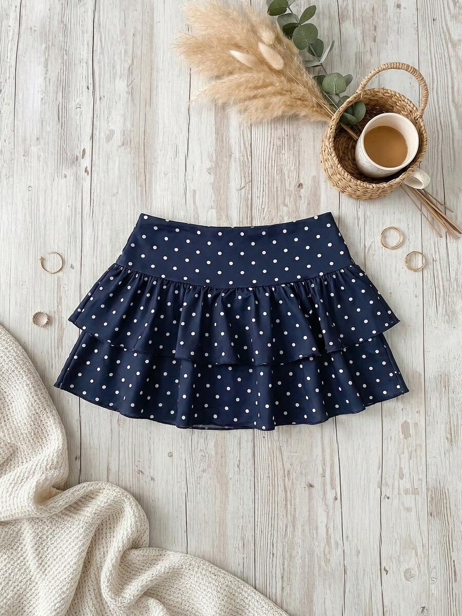 Black low waist knit mini skirt featuring a tiered ruffle hem and skinny high stretch fit.