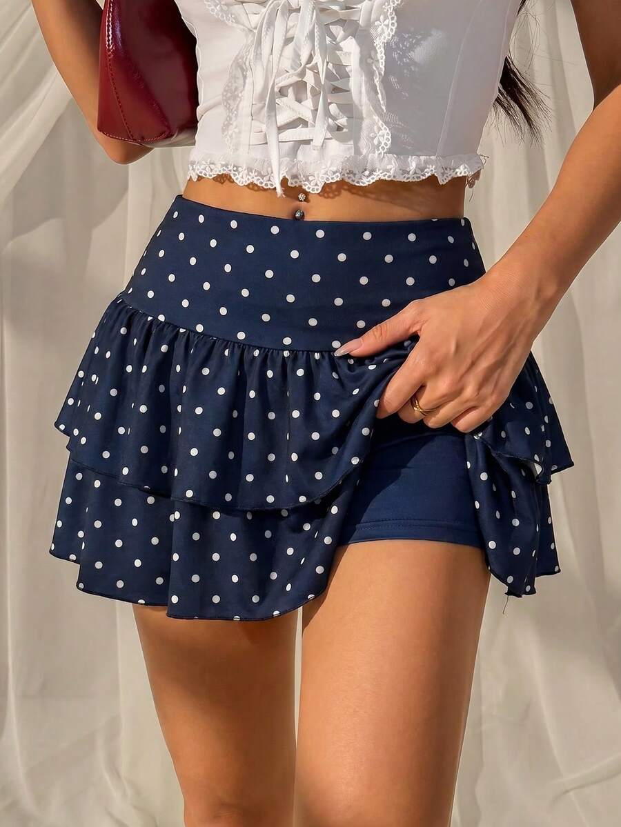 Black low waist knit mini skirt featuring a tiered ruffle hem and skinny high stretch fit.