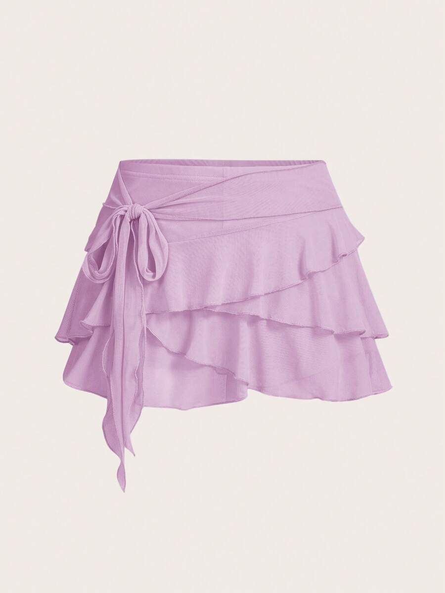 White tiered ruffle trim mini skirt for women with low waist, knot detail, mesh fabric, and casual Y2K boho design.