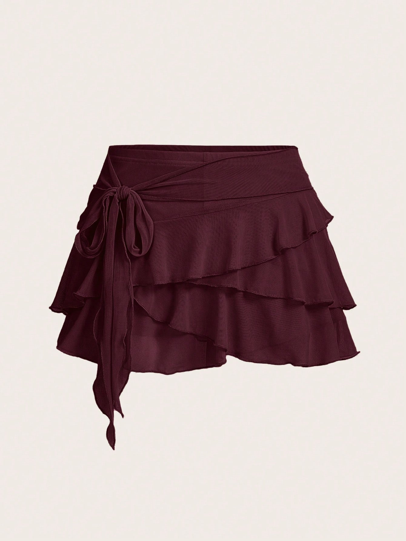 White tiered ruffle trim mini skirt for women with low waist, knot detail, mesh fabric, and casual Y2K boho design.