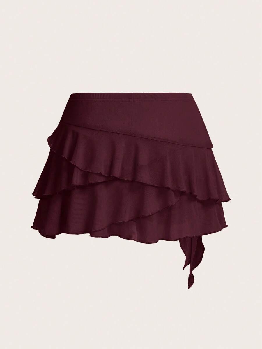 White tiered ruffle trim mini skirt for women with low waist, knot detail, mesh fabric, and casual Y2K boho design.