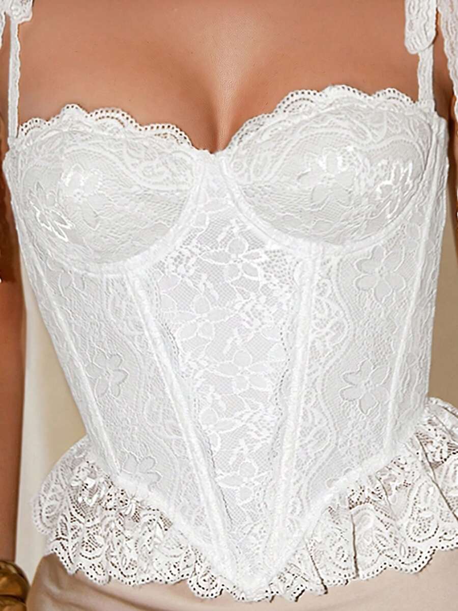 Women's lace camisole top featuring a boned bodice, sweetheart neckline, wide straps, and an asymmetrical crop hem.
