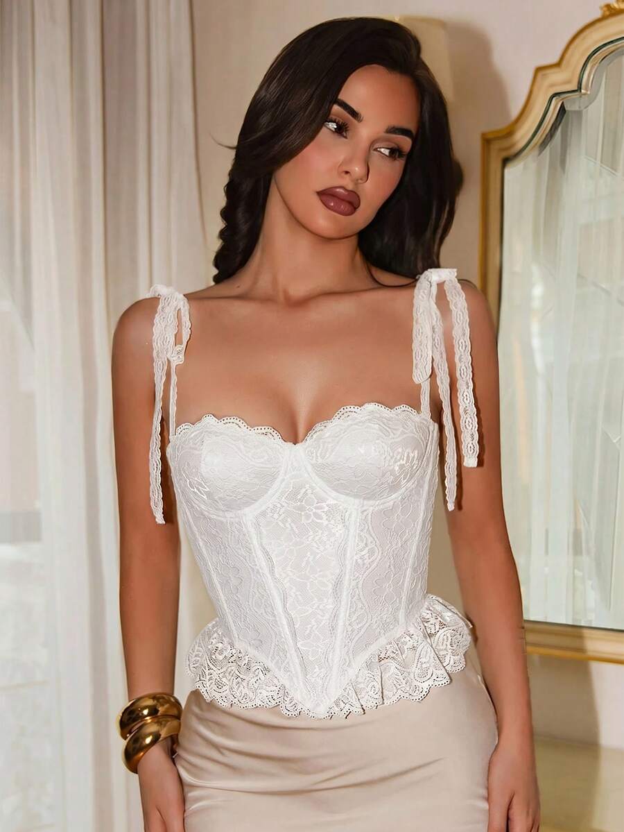 Women's lace camisole top featuring a boned bodice, sweetheart neckline, wide straps, and an asymmetrical crop hem.