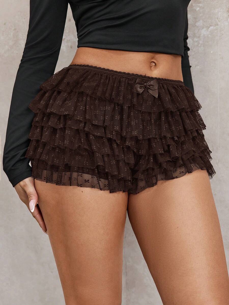 Apricot tiered lace ruffle hem low waist shorts for women featuring elastic waist and lined semi-sheer knit fabric.