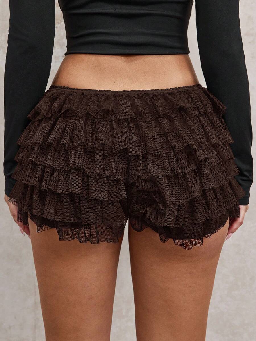Apricot tiered lace ruffle hem low waist shorts for women featuring elastic waist and lined semi-sheer knit fabric.
