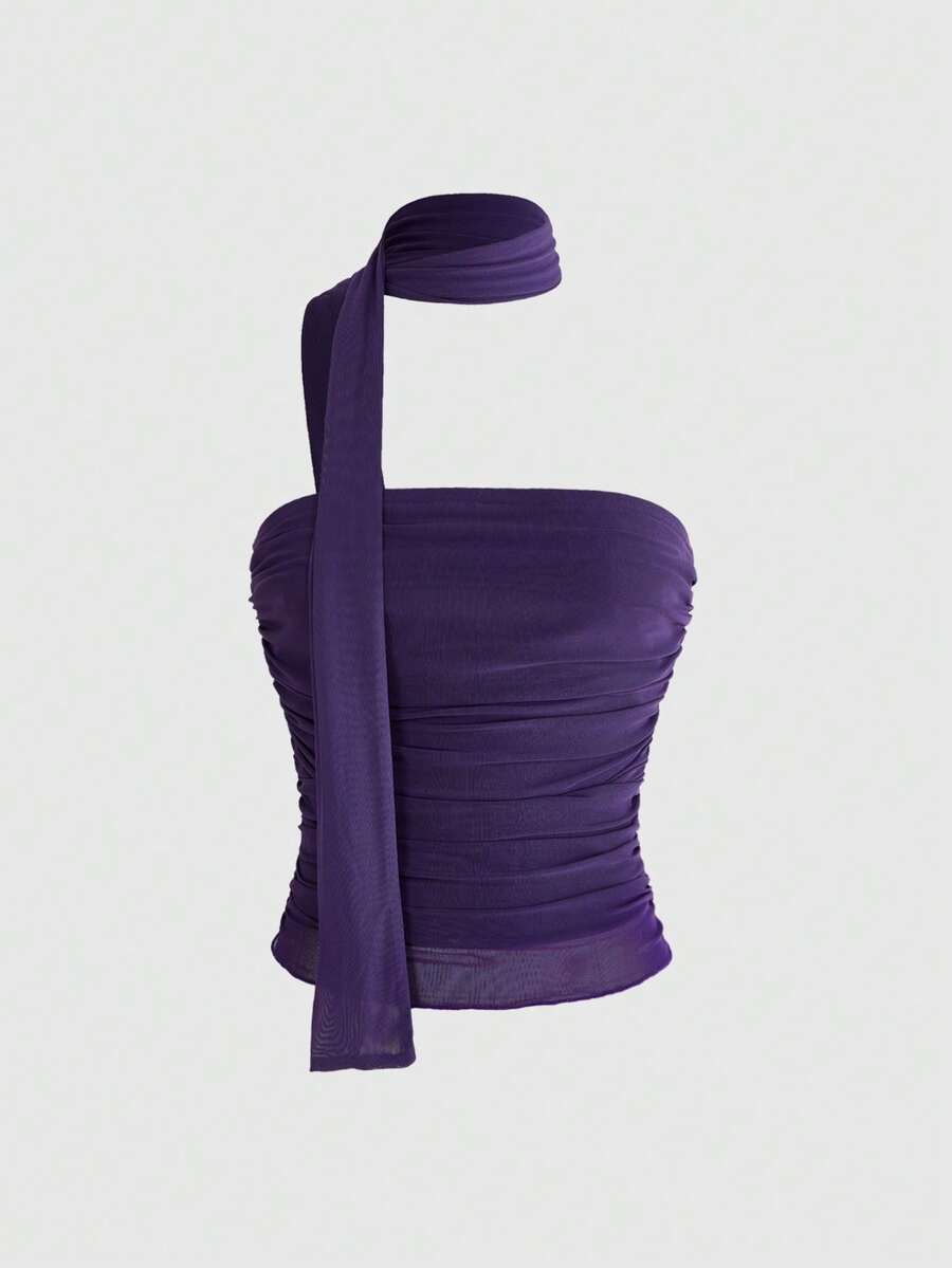 Women's black polka dot strapless tube top made of ruched mesh fabric featuring an asymmetrical hem and matching scarf.