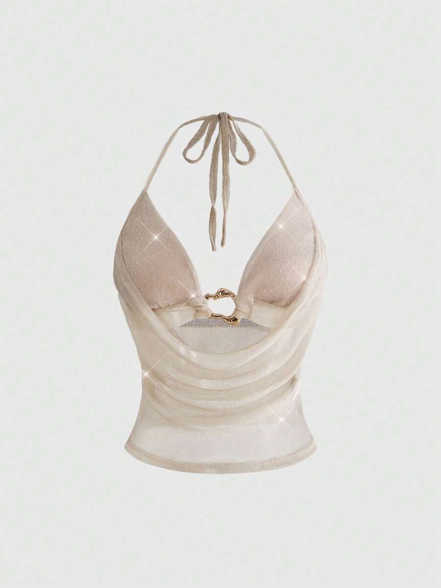 Women's glitter backless halter crop top with a draped neck and tie-up straps in metallic black knit fabric.