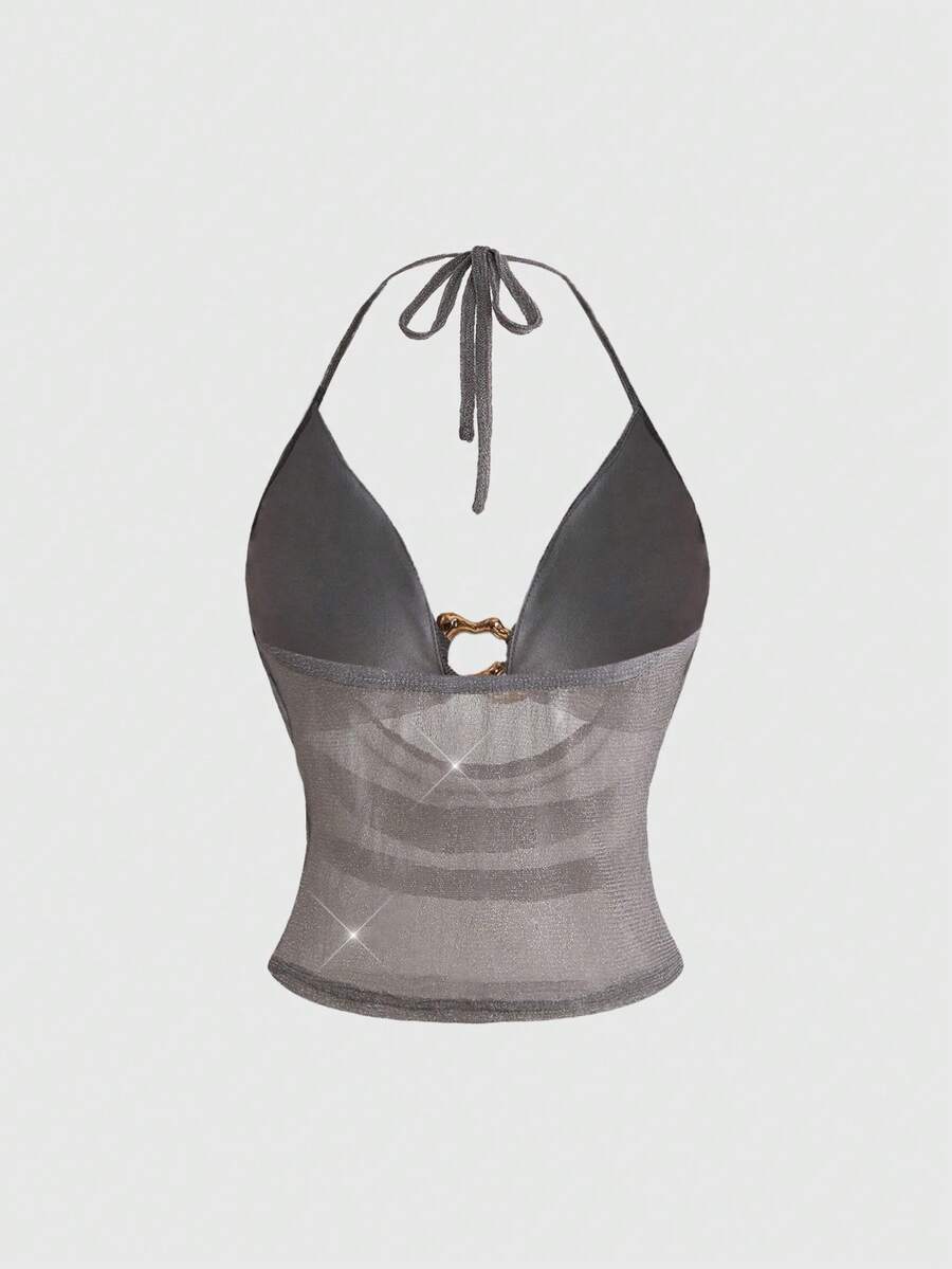 Women's glitter backless halter crop top with a draped neck and tie-up straps in metallic black knit fabric.