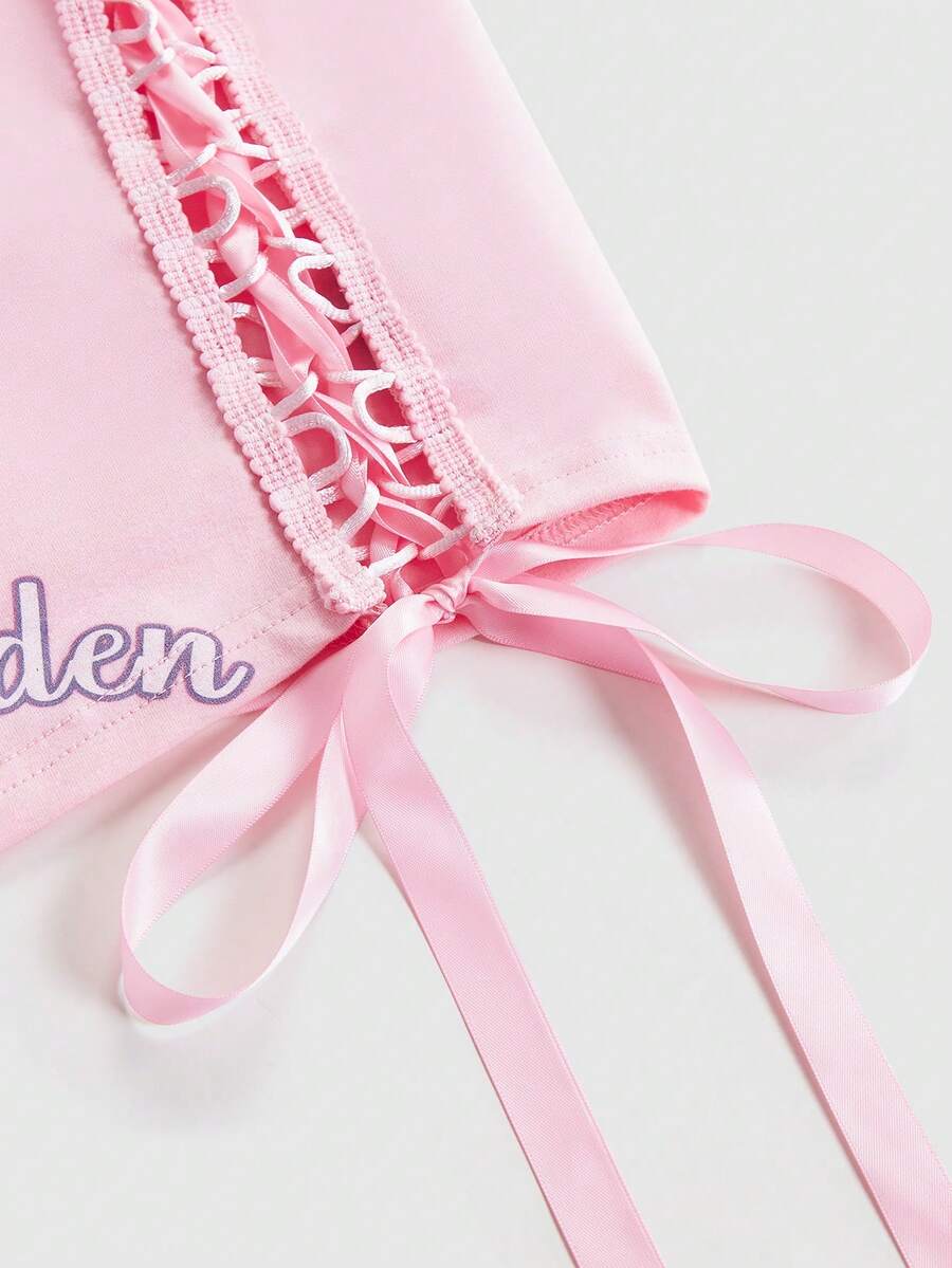 Pink slim fit cropped tank top with scoop neckline, featuring cute rabbit and heart print, rhinestone details, and front ribbon bow accent.
