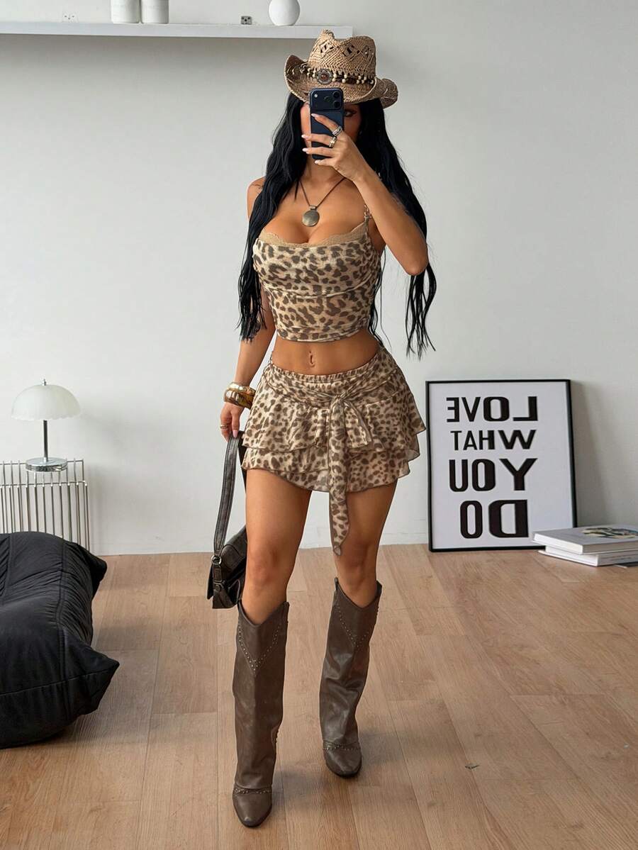 Black low waist tiered mini skirt featuring a ruffle hem and ring accent detail on knitted stretch fabric for women.