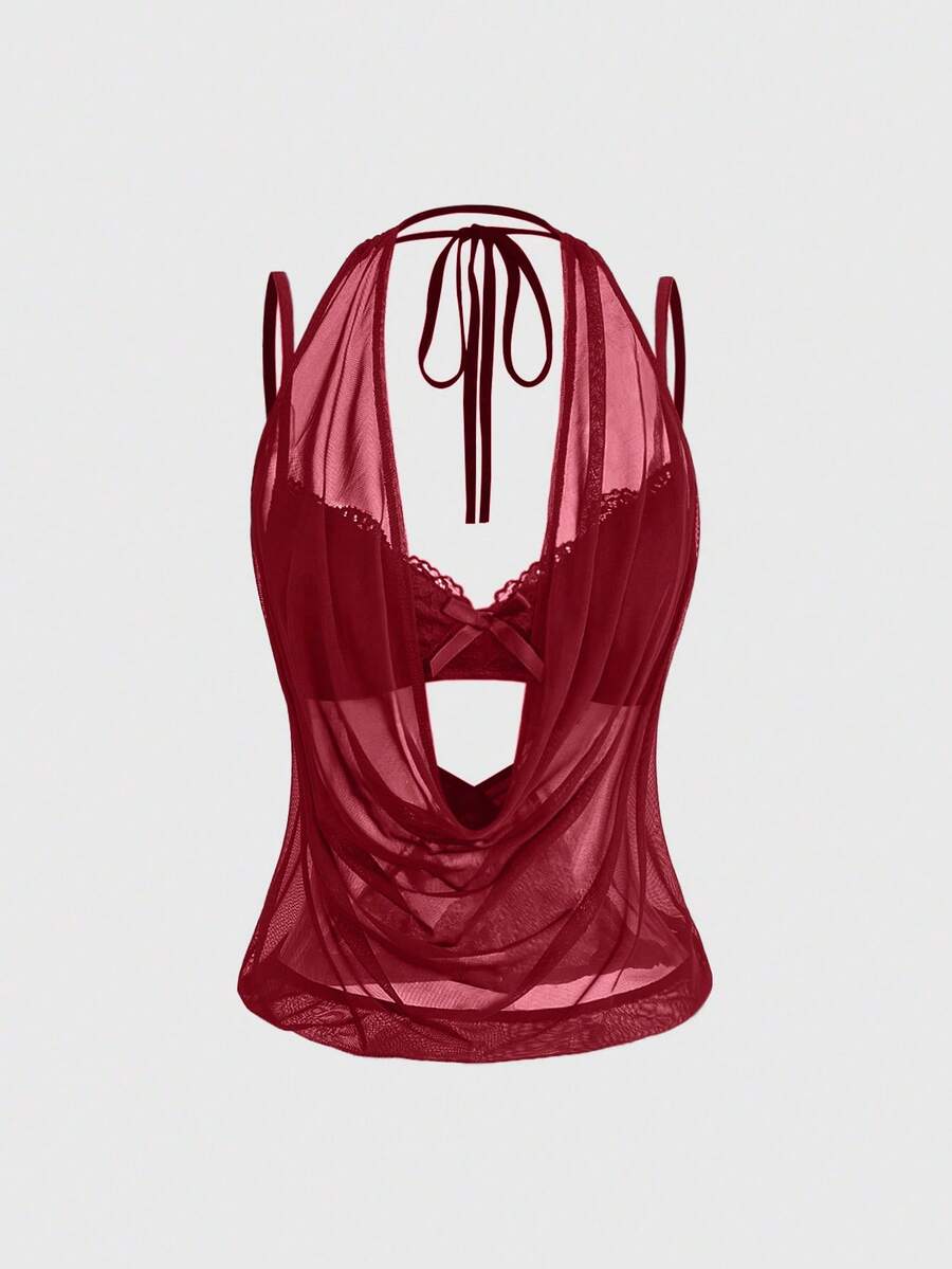 Women wearing a black draped backless halter crop top layered over a boned lace camisole.