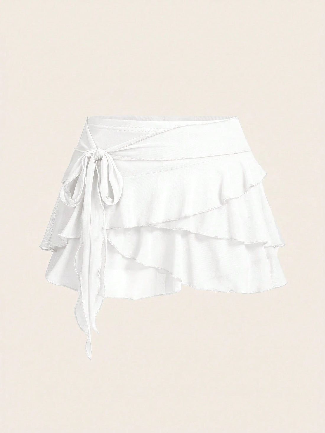 White tiered ruffle trim mini skirt for women with low waist, knot detail, mesh fabric, and casual Y2K boho design.