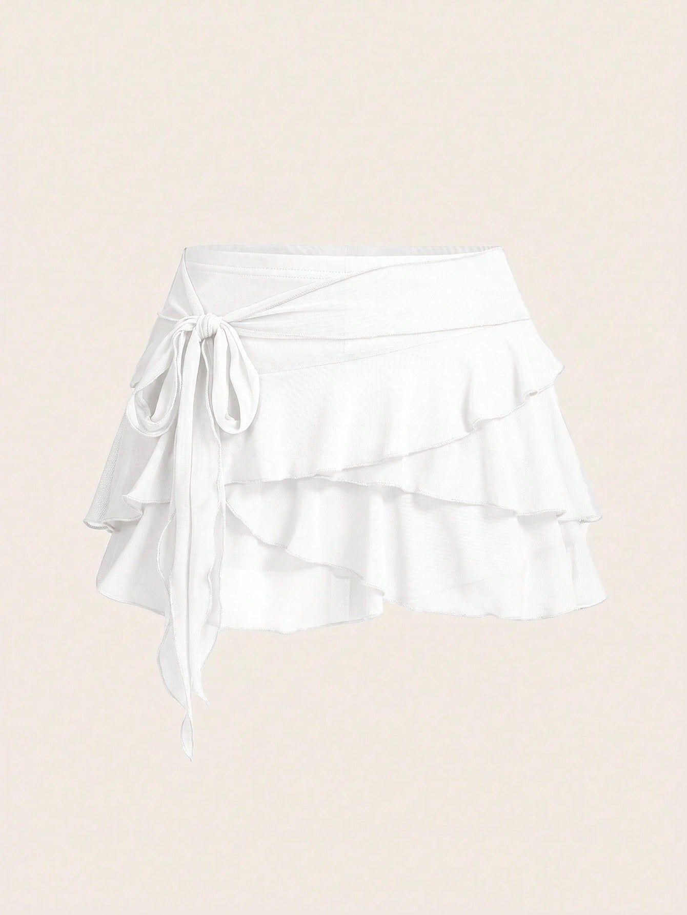 White tiered ruffle trim mini skirt for women with low waist, knot detail, mesh fabric, and casual Y2K boho design.