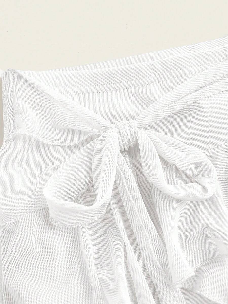 White tiered ruffle trim mini skirt for women with low waist, knot detail, mesh fabric, and casual Y2K boho design.